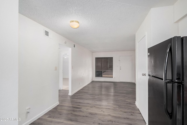 interior space featuring hardwood / wood-style floors and a textured ceiling