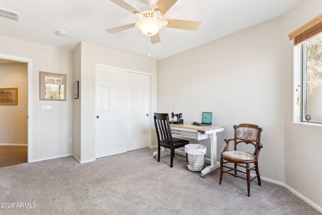 office space featuring light colored carpet and ceiling fan