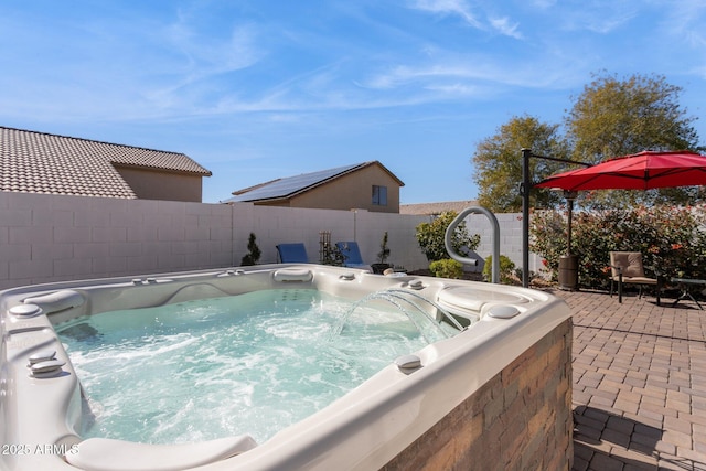 view of pool with a hot tub and a patio area