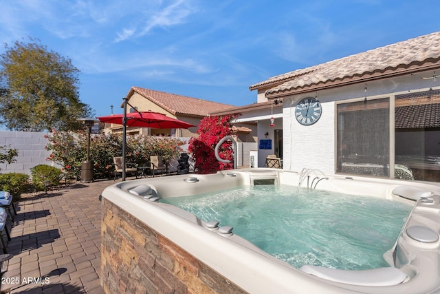 view of swimming pool featuring a hot tub