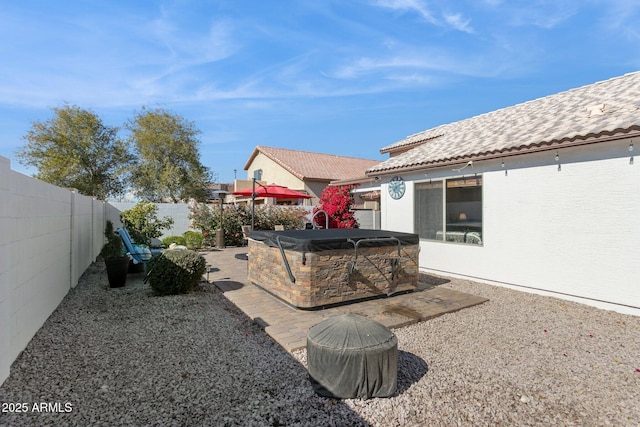 view of yard featuring a patio area and a hot tub