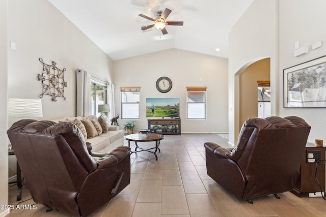 living room featuring ceiling fan and high vaulted ceiling