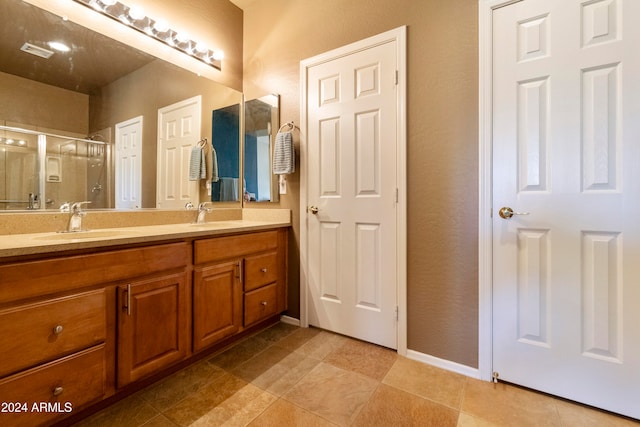 bathroom with tile patterned floors and dual bowl vanity