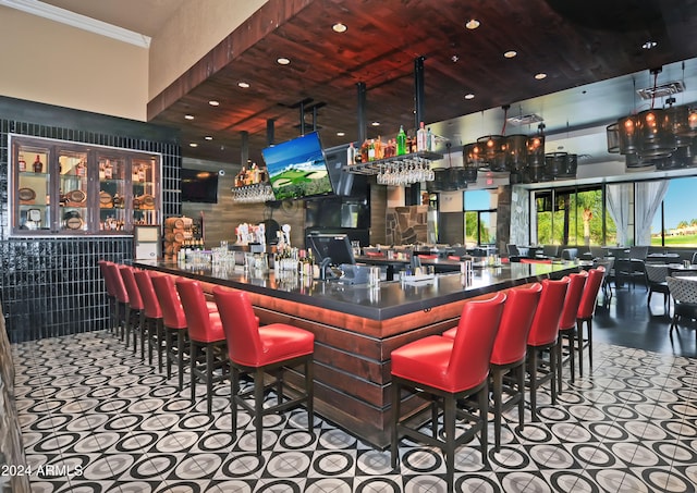 bar featuring tile patterned floors, tile walls, and wood ceiling