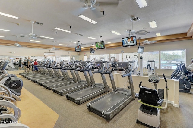 exercise room featuring ceiling fan and a textured ceiling