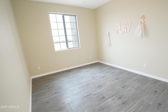 unfurnished room with hardwood / wood-style flooring