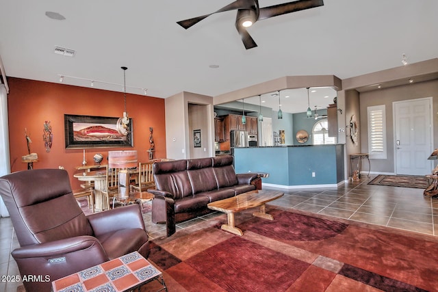 tiled living room featuring rail lighting and ceiling fan