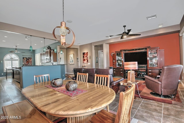 tiled dining room featuring ceiling fan