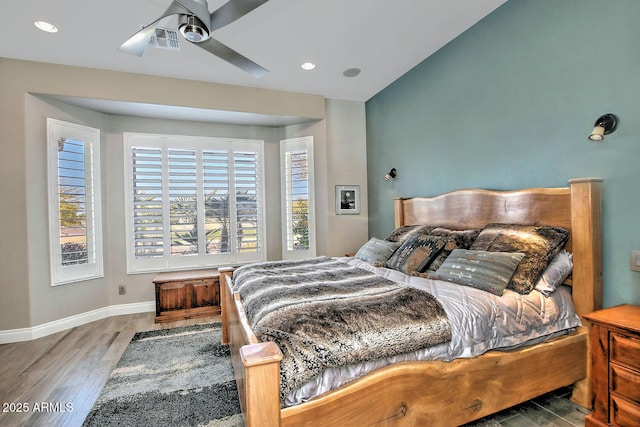 bedroom featuring hardwood / wood-style flooring and lofted ceiling