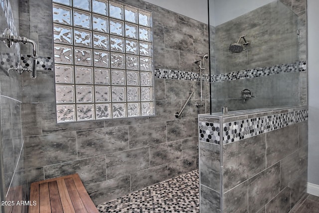 bathroom with a tile shower