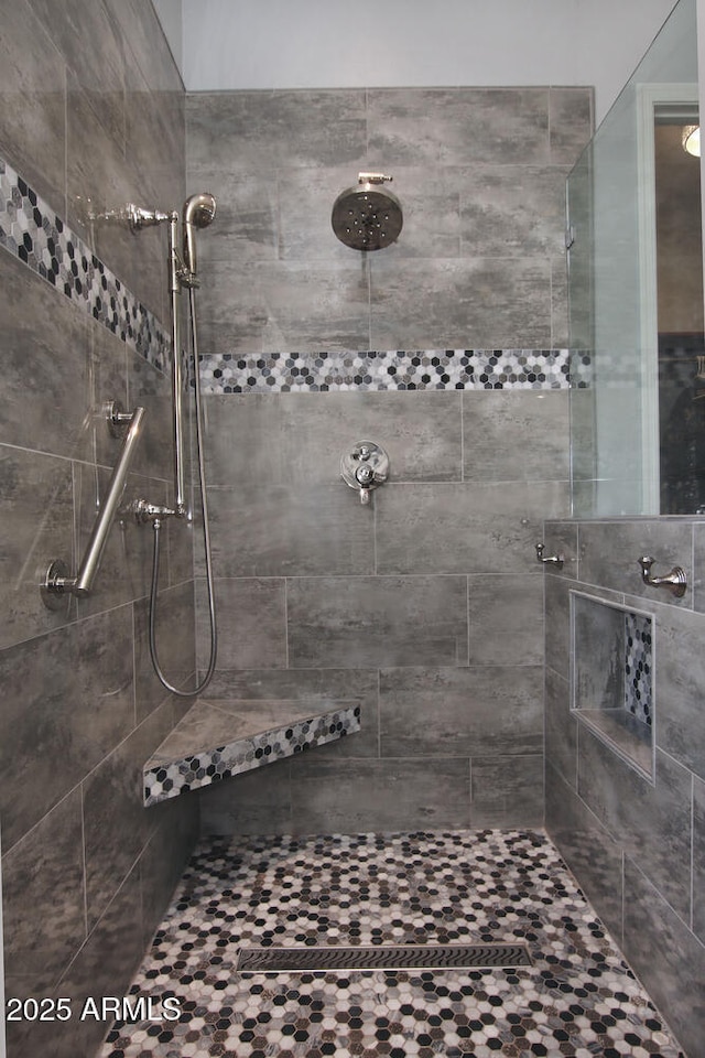 bathroom with a tile shower