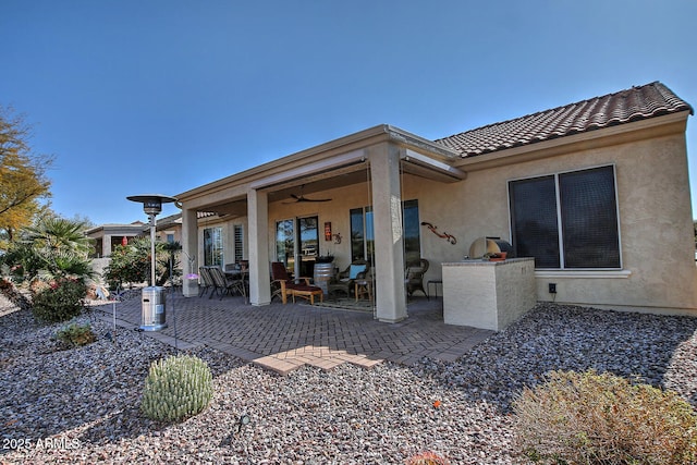 rear view of house with a patio and ceiling fan