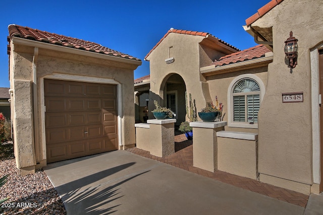 mediterranean / spanish house with a garage