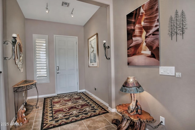 tiled entrance foyer featuring track lighting