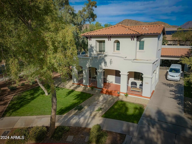 view of front of property with a porch and a front yard