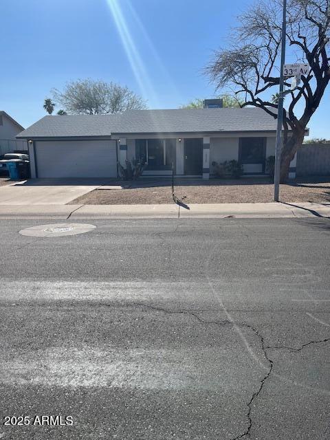 18028 N 33rd Ave N, Phoenix, AZ 85053 - view of front of home with an attached garage and driveway