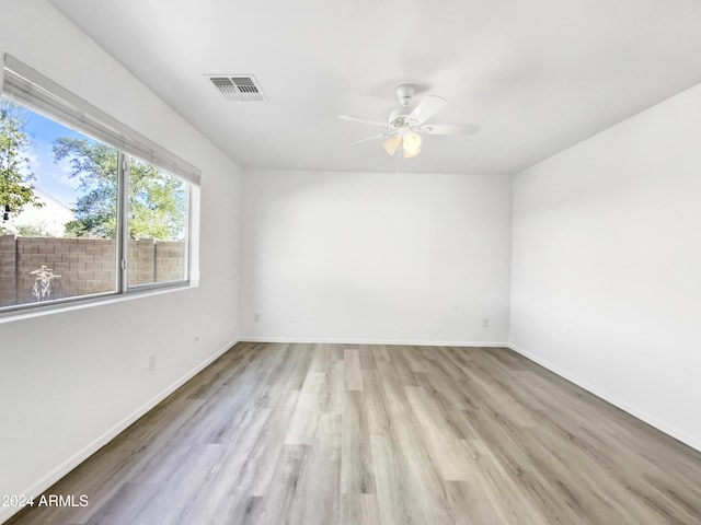 spare room with ceiling fan and light hardwood / wood-style flooring