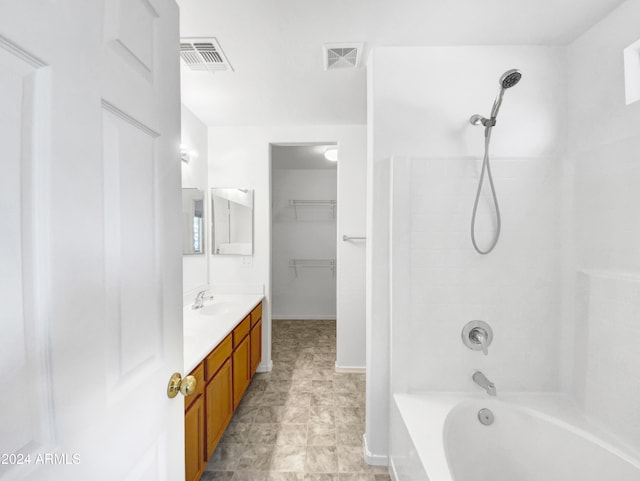 bathroom with vanity and tiled shower / bath combo