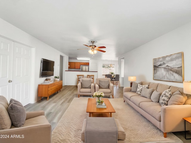 living room featuring light hardwood / wood-style floors and ceiling fan