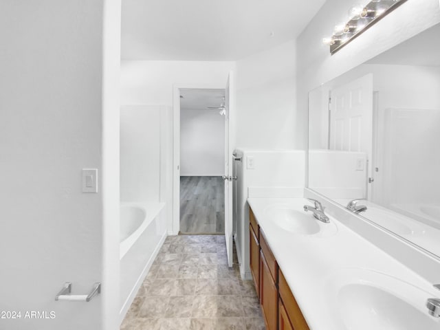 bathroom with a bathing tub and vanity