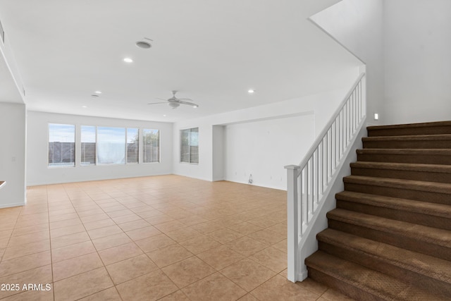 stairs featuring tile patterned floors and ceiling fan