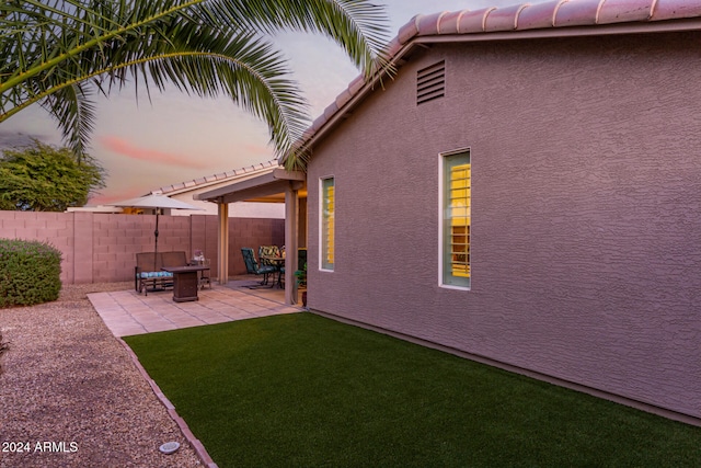 yard at dusk with a patio