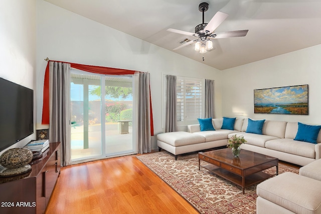 living room featuring lofted ceiling, hardwood / wood-style flooring, and ceiling fan