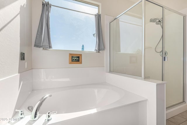 bathroom featuring tile patterned floors and independent shower and bath