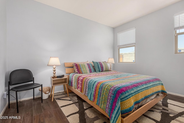 bedroom with dark hardwood / wood-style flooring