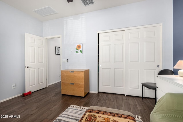 bedroom featuring dark hardwood / wood-style floors and a closet