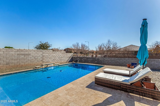 view of swimming pool with pool water feature and a patio area