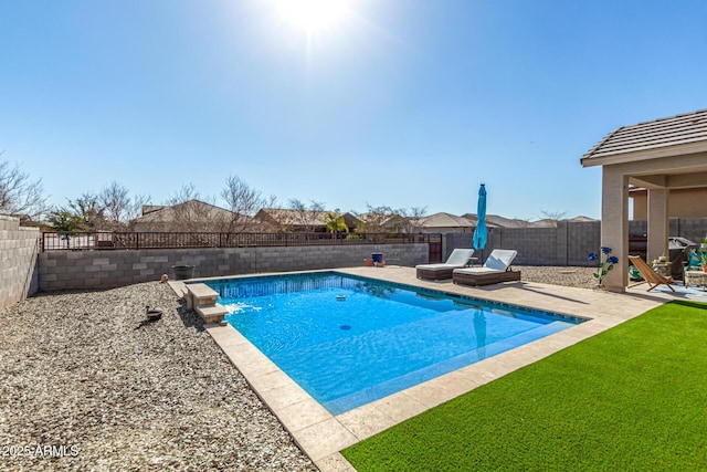 view of swimming pool featuring a yard and a patio area