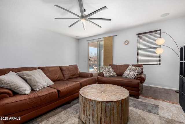 living room featuring ceiling fan and light hardwood / wood-style floors