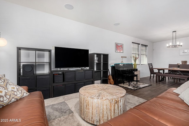 living room with dark hardwood / wood-style flooring and a chandelier