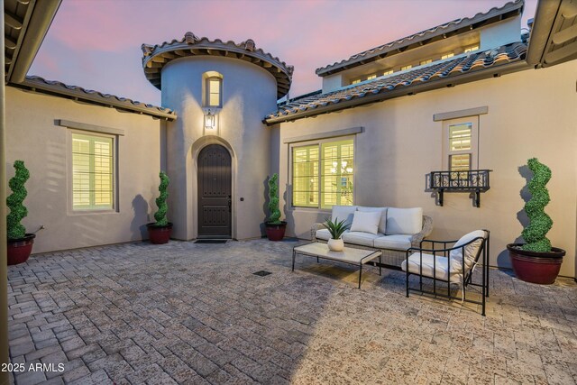 patio terrace at dusk with an outdoor hangout area