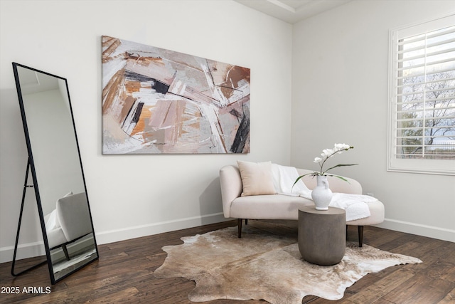 living area featuring baseboards and wood finished floors