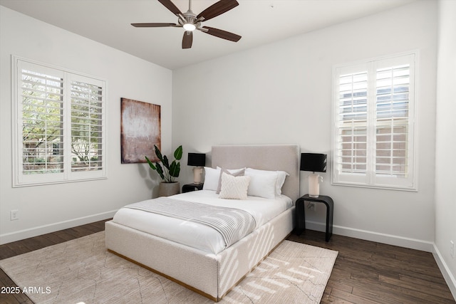 bedroom with baseboards, wood finished floors, and a ceiling fan