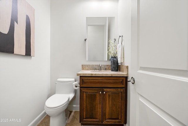 bathroom with tile patterned floors, baseboards, toilet, and vanity