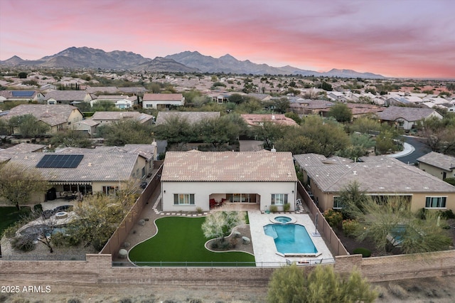 aerial view at dusk featuring a residential view and a mountain view