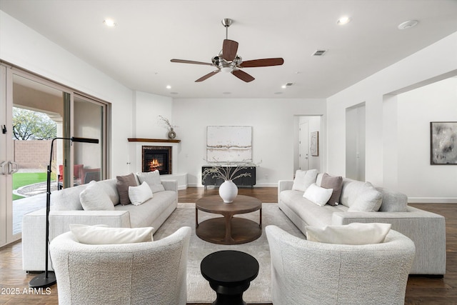 living area with recessed lighting, visible vents, baseboards, and dark wood-style floors