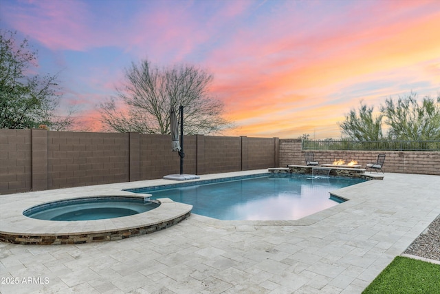 view of swimming pool featuring a patio, a fenced backyard, and a pool with connected hot tub