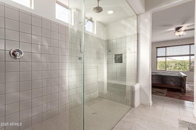 bathroom featuring tile patterned floors, ceiling fan, and a tile shower