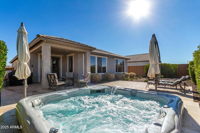 view of swimming pool with a patio area and a hot tub