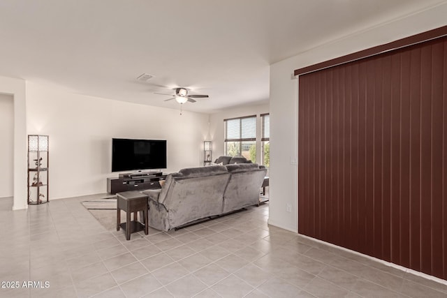 tiled living room with ceiling fan