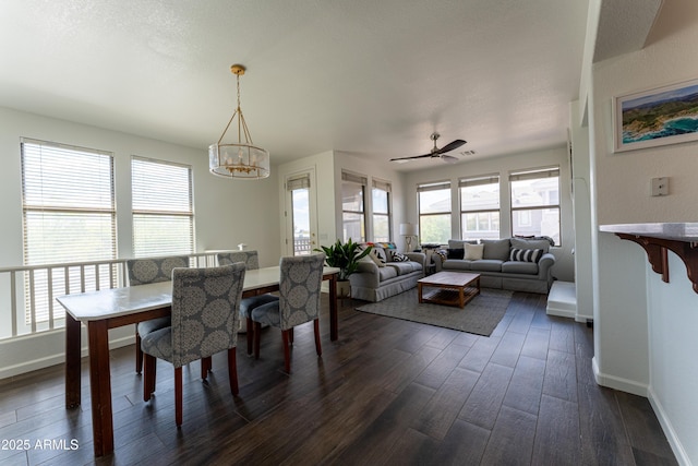 15221 N Clubgate Dr Unit 2132, Scottsdale, AZ 85254 - dining space with ceiling fan with notable chandelier, baseboards, and dark wood finished floors