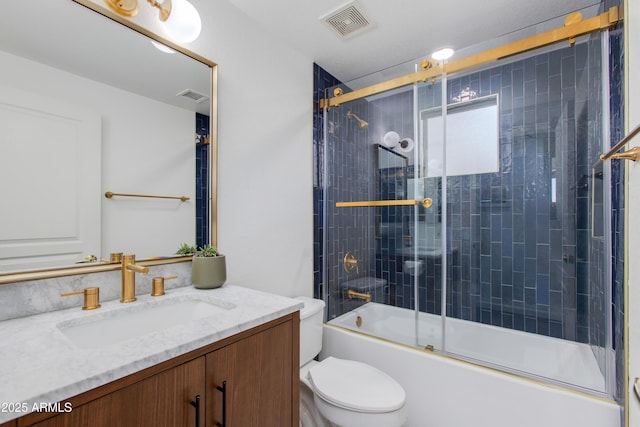 15221 N Clubgate Dr Unit 2132, Scottsdale, AZ 85254 - full bathroom featuring combined bath / shower with glass door, visible vents, vanity, and toilet