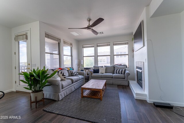 15221 N Clubgate Dr Unit 2132, Scottsdale, AZ 85254 - living area featuring dark wood finished floors, visible vents, baseboards, a glass covered fireplace, and ceiling fan