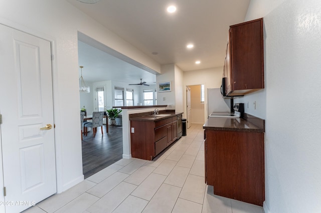 15221 N Clubgate Dr Unit 2132, Scottsdale, AZ 85254 - kitchen with light tile patterned flooring, dark countertops, recessed lighting, ceiling fan, and black microwave