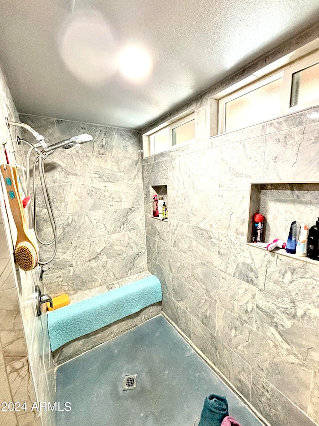 bathroom featuring a shower and a textured ceiling