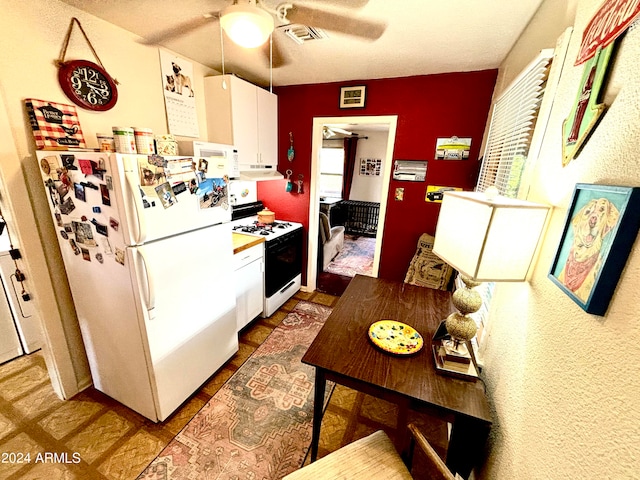 kitchen with white appliances, white cabinetry, and ceiling fan